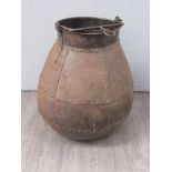 A large rivetted iron cauldron with handle and hanging hook