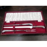 WITHDRAWN - An EPNS three piece carving set with pistol grip handles.