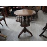 A mahogany circular top occasional table with revolving bookshelf underneath, 66cm tall,