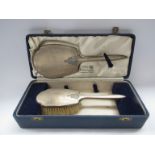 A silver two piece dressing table set by William Neale and Son Ltd,