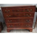 A George III mahogany straight front chest of four long graduated drawers with brushing slide,