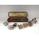 A silver scent bottle with glass stopper, pill box, fruit knife and fork,