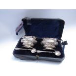 A pair of Barker Bros silver salts with scroll detail, blue glass liners,