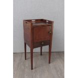 A George III mahogany nightstand the fret handles to raised gallery over a single door and drawer