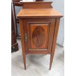 An Edwardian cross-banded mahogany bedside pot cupboard on tapering square section legs,