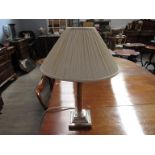 A silver plated column form lamp,