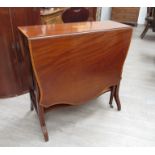 An Edwardian inlaid mahogany Sutherland table with serpentine-shaped flaps,