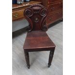 A William IV mahogany hall chair, with painted unicorn crest to the back cartouche,