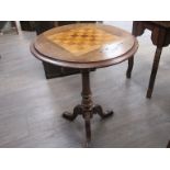 A Victorian walnut and mixed wood circular chess table on a tripod base. 52cm diameter.