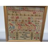 A Victorian woolwork mixed-stitch sampler by "Ann Woolston, Scratby, Aged 7 Years, 1846",