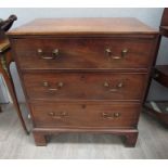 A George III mahogany straight front chest of three long drawers on bracket feet.