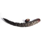 A highly carved Chinese opium pipe of curved form,