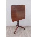 A George III flame mahogany round corner square tilt top wine table on a ring turned column and