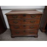 A George III cross-banded mahogany straight front chest of four long drawers on bracket feet.
