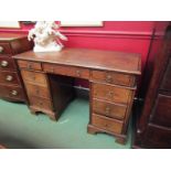 A late Victorian oak twin pedestal desk with Gothic drop handles,