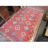 A red ground Kilim rug, four geometric gulls.