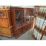 A mahogany astral glazed bookcase with undertier cupboards