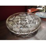 A heavy cut glass shallow bowl, chipped,