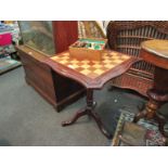 A hand carved wooden chess set with mahogany chess table on tripod base