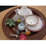 A wooden bowl with various china and ornaments