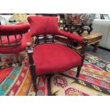 A late 19th Century mahogany tub chair with red velour upholstery on serpentine front