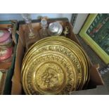 A box of brass chargers, decanters, candelabra,