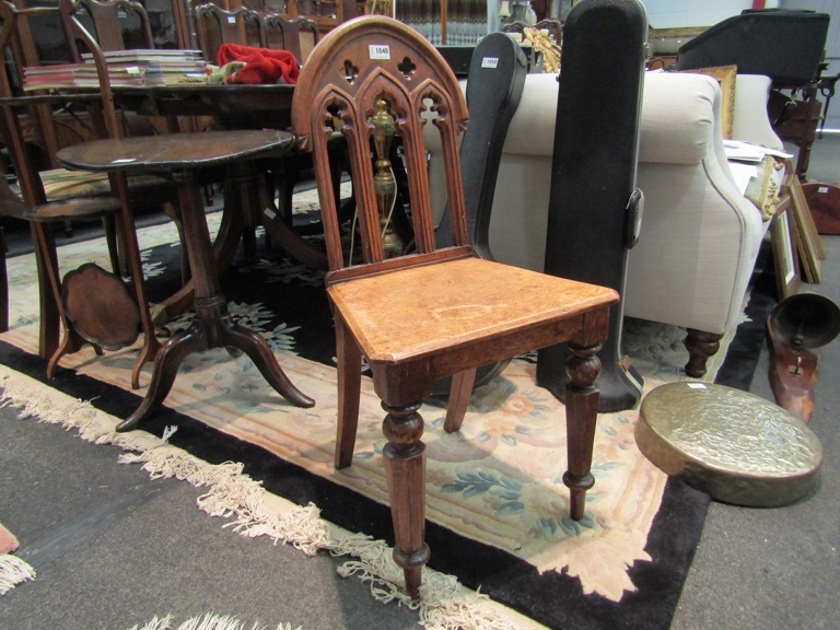 A Victorian carved oak hall chair of Gothic design