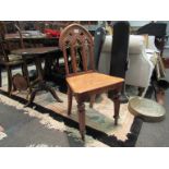 A Victorian carved oak hall chair of Gothic design