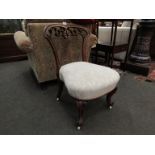 A Victorian walnut nursing chair, pierced scroll back support,