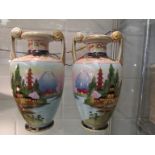 A pair of Japanese noritake vases with landscape scenes,