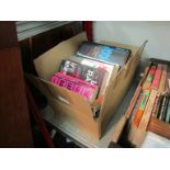 A box of crime fiction books,
