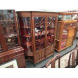 An Edwardian style mahogany glazed display cabinet, astragal glazed doors,bowed glazed sides,