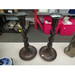 A pair of barley twist candlesticks with drip trays,
