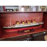 A handbuilt model ship of the Titanic on stand,