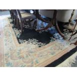 A large Chinese floral design black ground carpet,