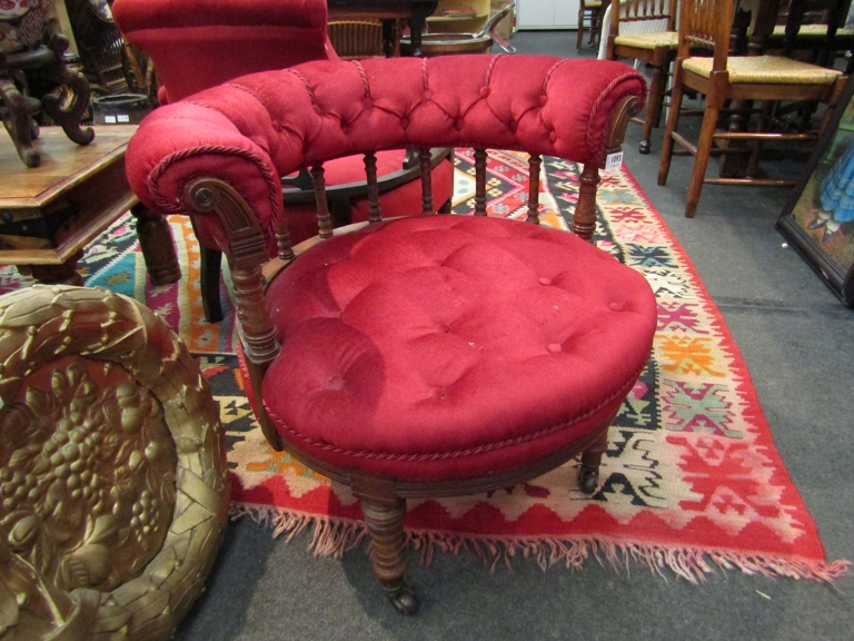 A Victorian spindle back tub chair with red velour upholstery