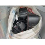 A bag of camera equipment including a Pentax P30,