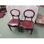 A set of four Victorian mahogany spoon back chairs with carved bar back rest over a leather seat
