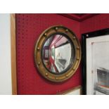 A gilt framed 19th Century porthole style mirror,