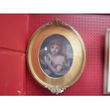 A gilt framed oval oil, mounted to board, portrait after JB Greuze.