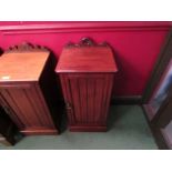 A late Victorian walnut bedside cupboard the carved raised back over a single door on a plinth base,