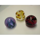 Two Caithness art glass paperweights including bubble design and an amber coloured Langham bubble
