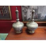 A pair of Far Eastern brass lidded bottle vases, all over detail,