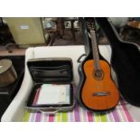 A Dulcet Classical acoustic guitar in hard case and a collection of music books including guitar