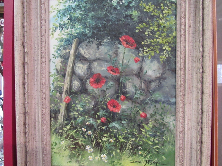 BARBARA MCINTYRE (XX) A framed oil on canvas of poppies by a stone wall,