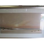 A coloured print of a beach scene, framed and glazed,