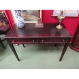An Edwardian mahogany writing table with beaded edge decoration over two frieze drawers on square