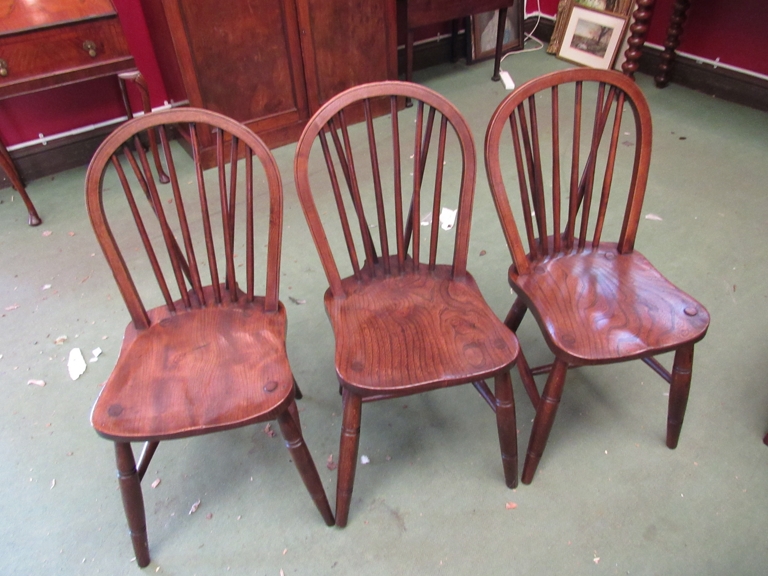 a set of six elm seated stick-back chairs with ring turned legs on "H" stretcher