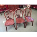 a set of six elm seated stick-back chairs with ring turned legs on "H" stretcher