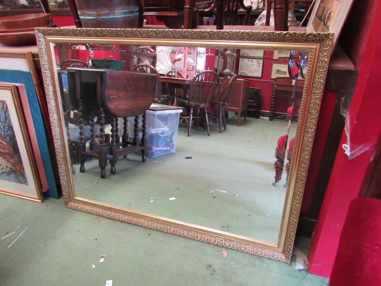 A rectangular gilt framed mirror with bevelled edge,